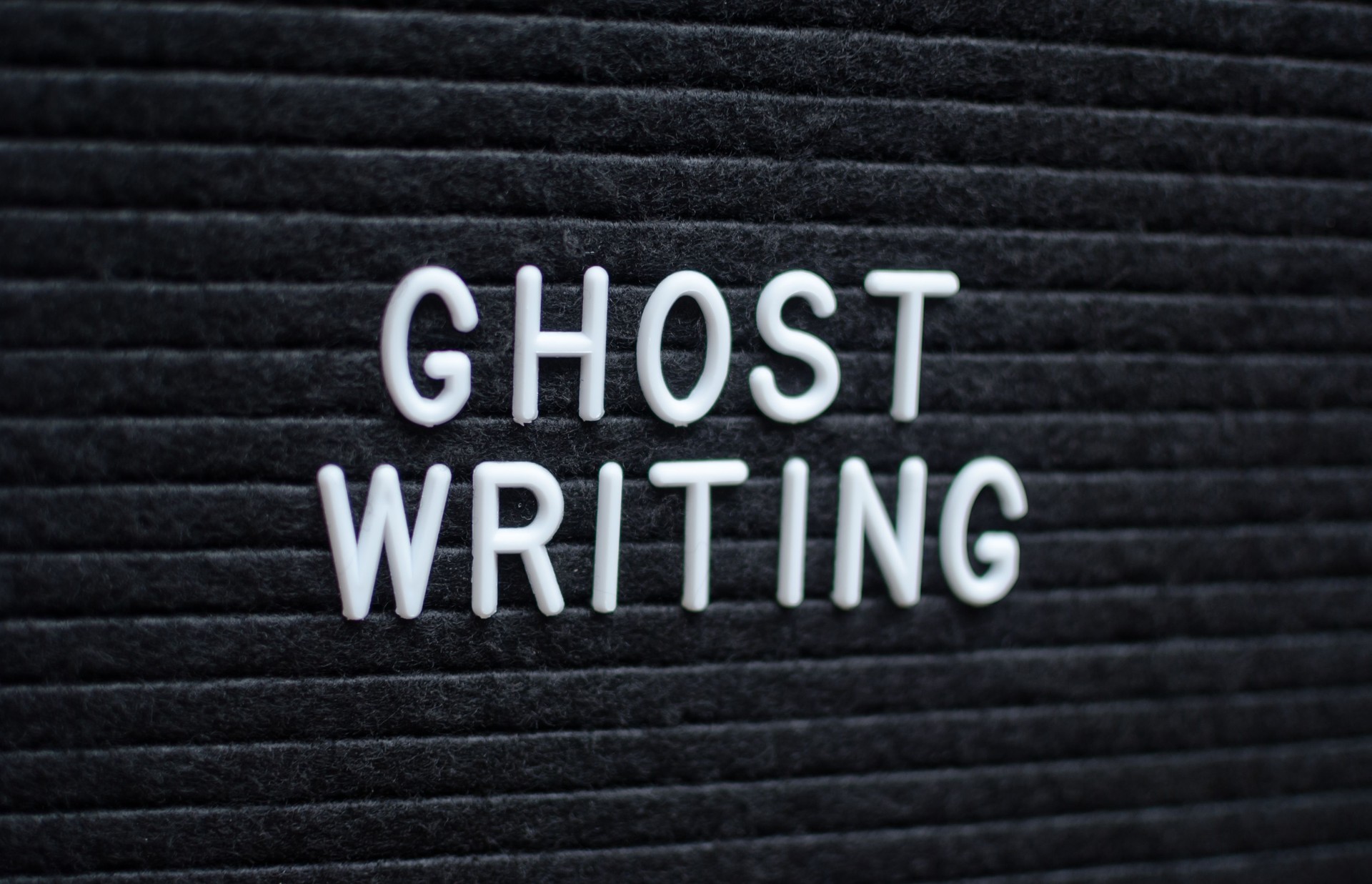 Words ghost writing written on the letter board.